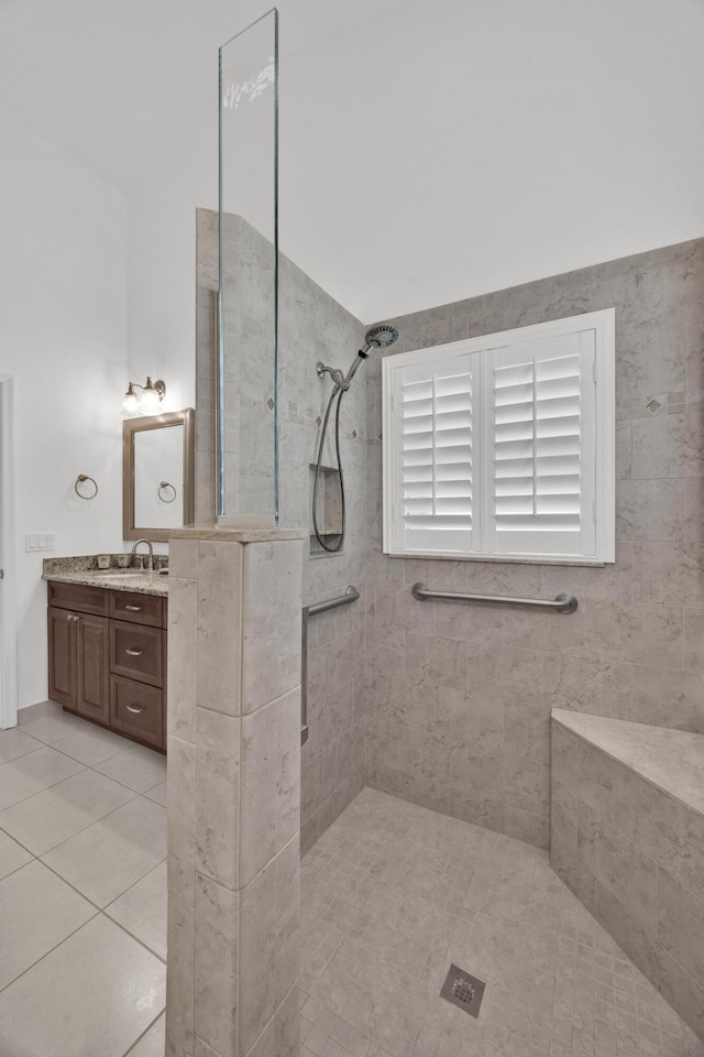 full bathroom with tiled shower, vanity, and tile patterned floors