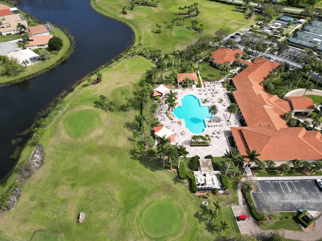 drone / aerial view with a water view and golf course view