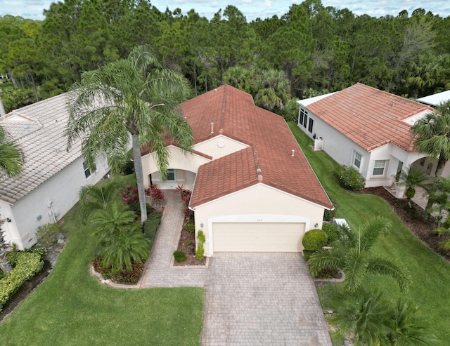 bird's eye view with a wooded view