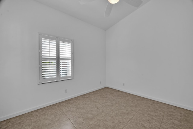 spare room featuring a ceiling fan, lofted ceiling, and baseboards