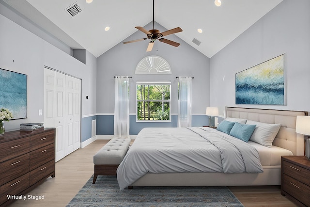 bedroom featuring ceiling fan, high vaulted ceiling, light wood-style flooring, and visible vents