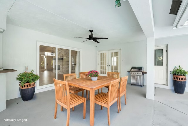 dining area featuring finished concrete floors, french doors, and ceiling fan