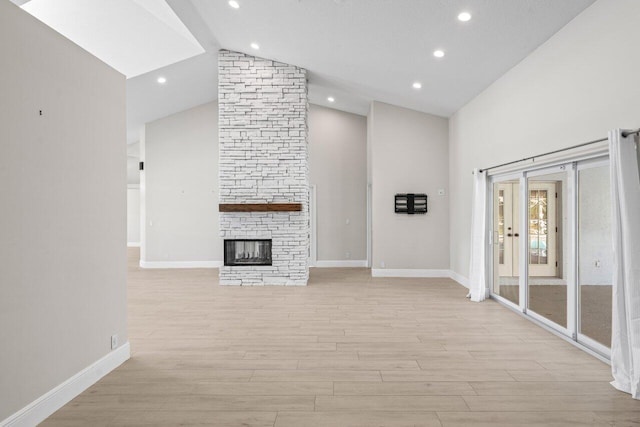 unfurnished living room with light wood-style floors, a fireplace, and baseboards