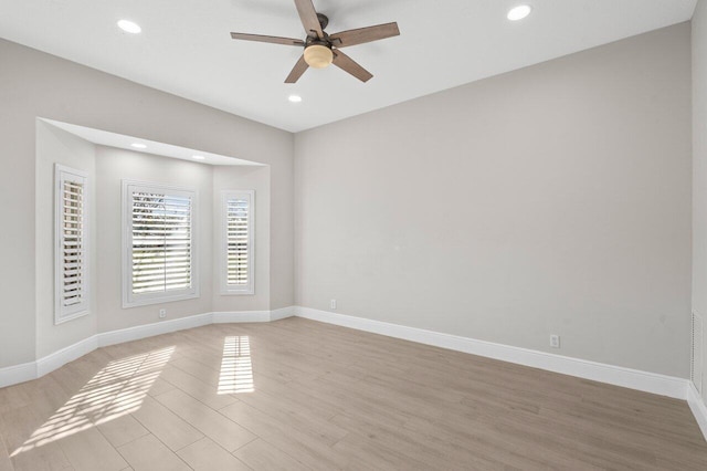 spare room with light wood-style floors, baseboards, a ceiling fan, and recessed lighting