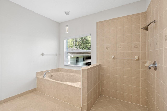 full bath featuring tile patterned floors, tiled shower, baseboards, and a bath