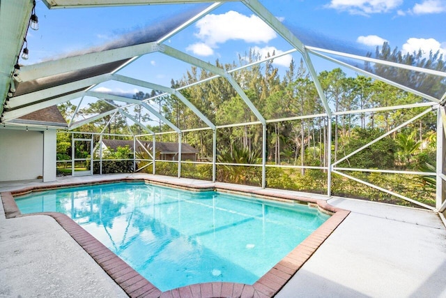 pool with a lanai and a patio area