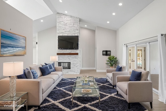 living room with baseboards, light wood-style flooring, a fireplace, high vaulted ceiling, and recessed lighting