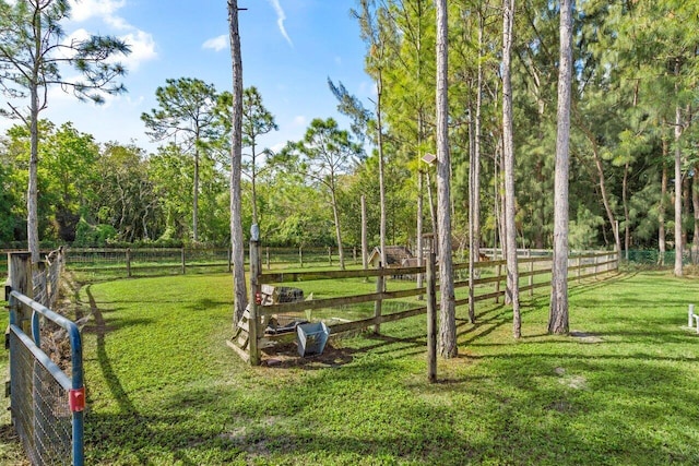 view of yard featuring a rural view and fence