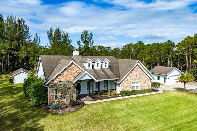 view of front of property with a porch, a front yard, and stone siding