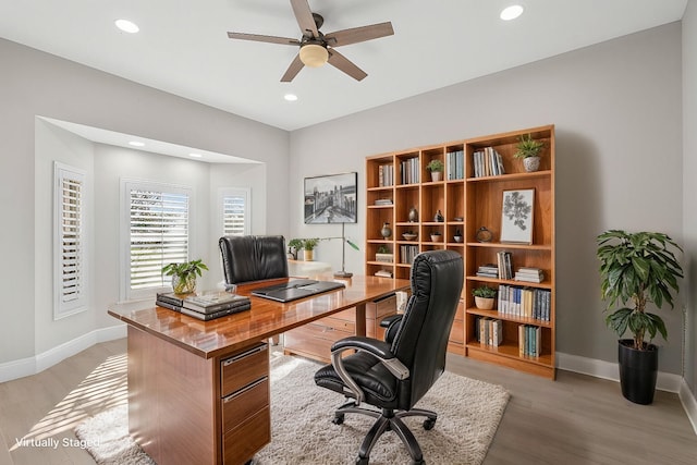 home office with a ceiling fan, recessed lighting, light wood-style flooring, and baseboards