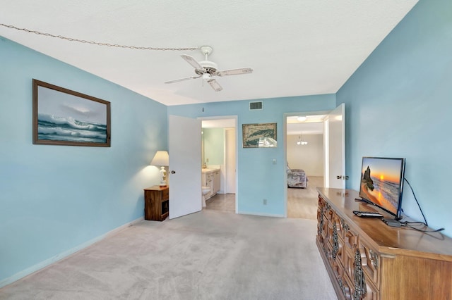 bedroom with connected bathroom, carpet flooring, visible vents, and baseboards