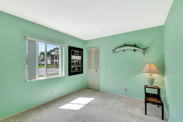 interior space with a textured ceiling and baseboards