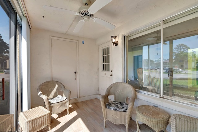 sunroom / solarium with a ceiling fan