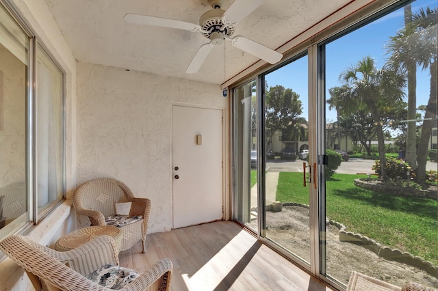 sunroom featuring a ceiling fan