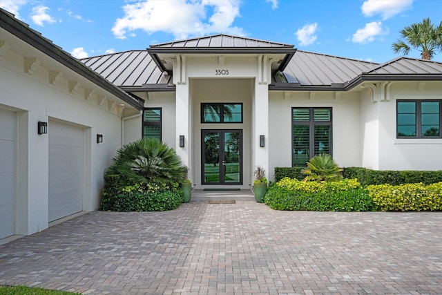 doorway to property featuring metal roof and a standing seam roof