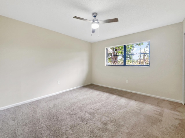 unfurnished room featuring a ceiling fan, carpet flooring, a textured ceiling, and baseboards