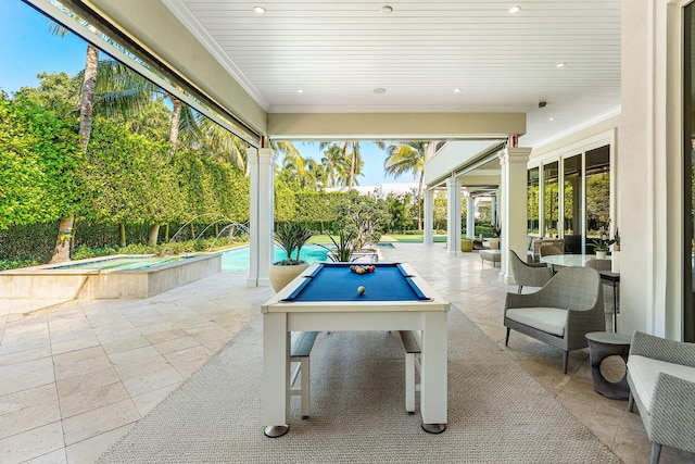 view of patio / terrace featuring an in ground hot tub and an outdoor pool