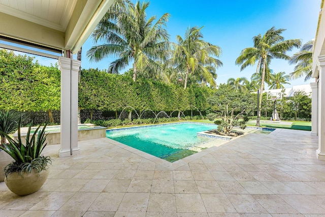 view of pool featuring a patio and a pool with connected hot tub