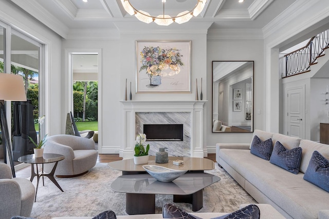 living room featuring a high end fireplace, crown molding, and coffered ceiling