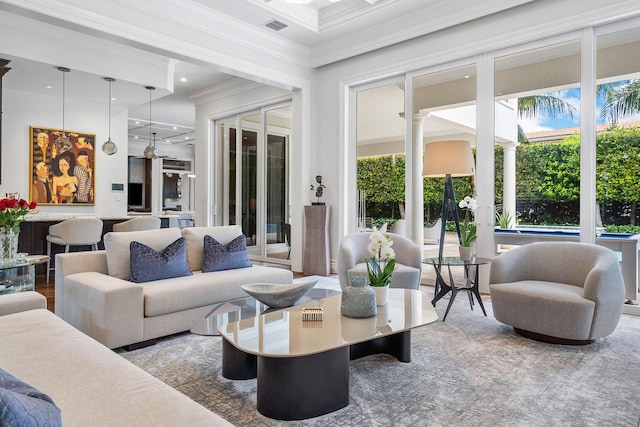 living room with crown molding and visible vents