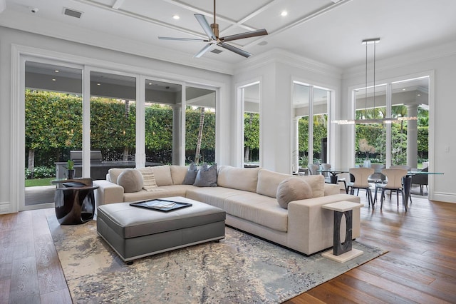 living room featuring hardwood / wood-style flooring, crown molding, coffered ceiling, and ceiling fan