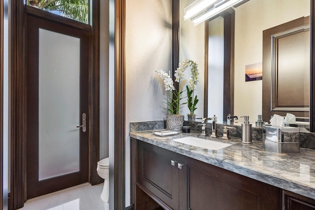 half bath featuring toilet and vanity