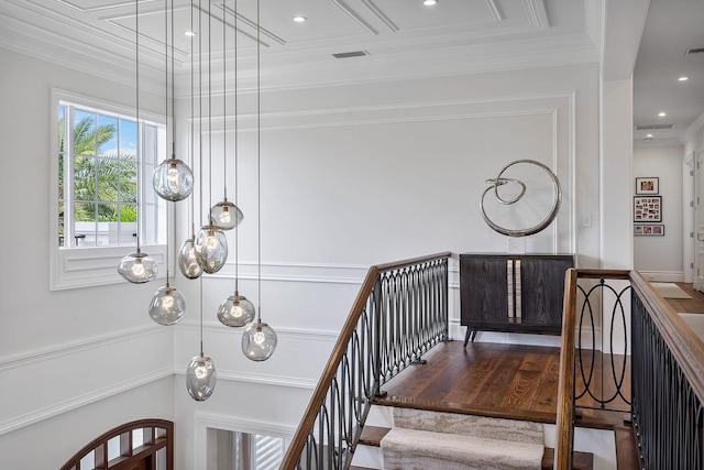 stairs with recessed lighting, visible vents, wood finished floors, and crown molding