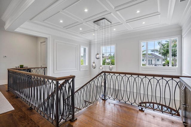 stairway featuring wood-type flooring, recessed lighting, coffered ceiling, and ornamental molding