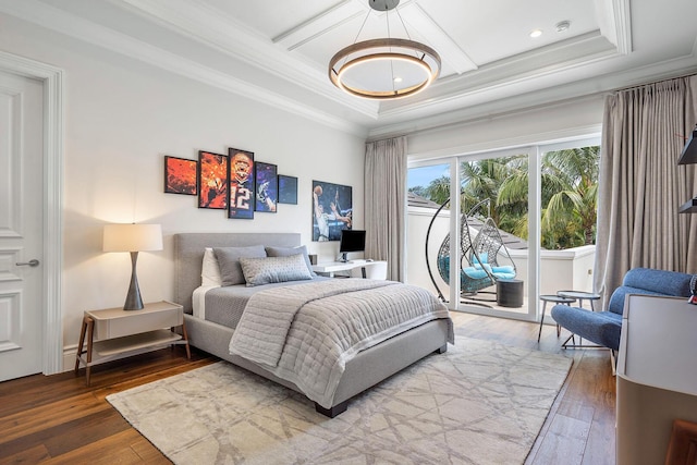 bedroom with ornamental molding, wood-type flooring, an inviting chandelier, and access to outside