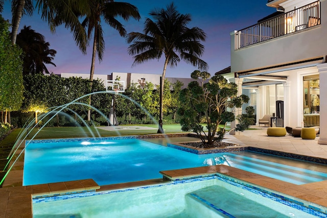 view of pool with an in ground hot tub and a patio area