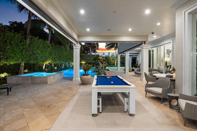 patio terrace at dusk with an in ground hot tub and an outdoor pool