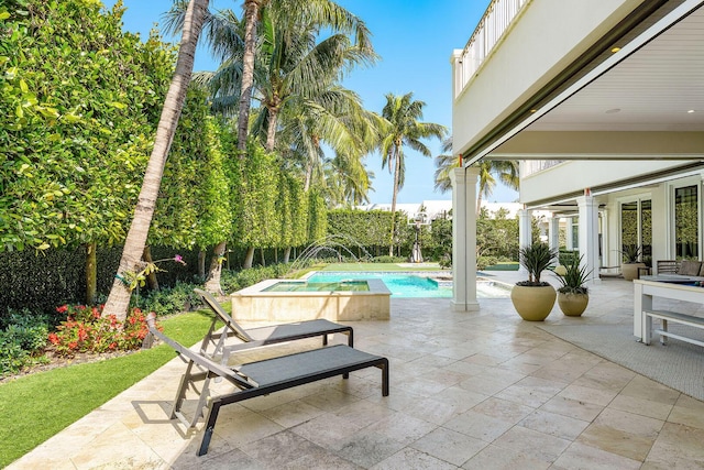 view of swimming pool with an in ground hot tub, a fenced in pool, and a patio