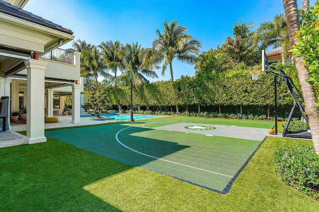 view of basketball court featuring a lawn and a fenced in pool