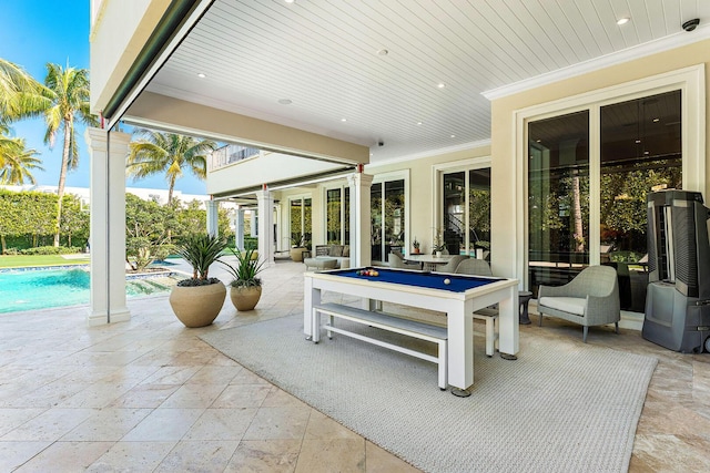 view of patio featuring an outdoor pool and a balcony