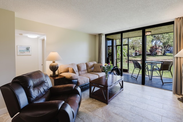 living room with expansive windows and a textured ceiling