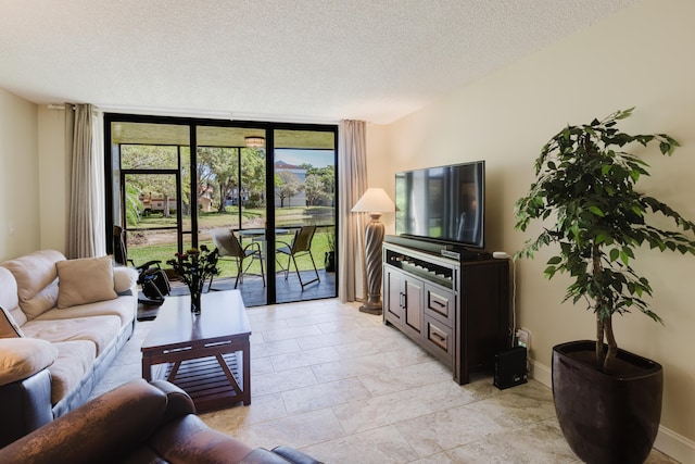 living area with a textured ceiling, baseboards, and floor to ceiling windows