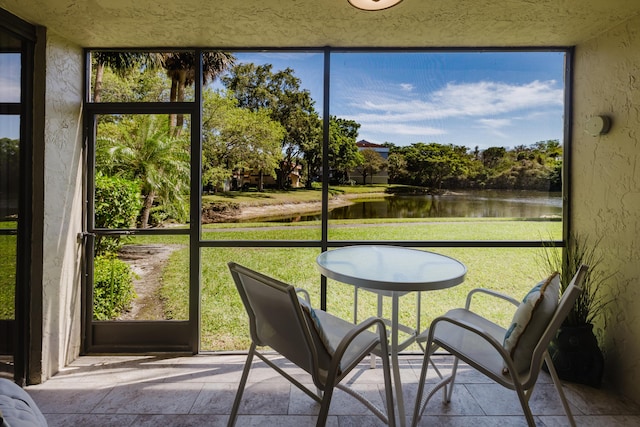 sunroom / solarium with a water view