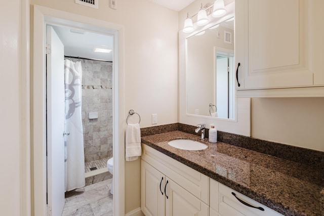 full bathroom featuring visible vents, a stall shower, vanity, and toilet