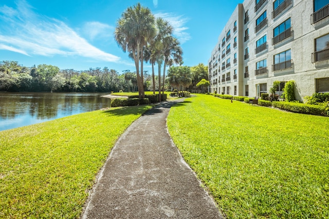 view of home's community featuring a yard and a water view