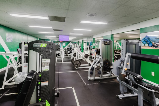 exercise room featuring a drop ceiling