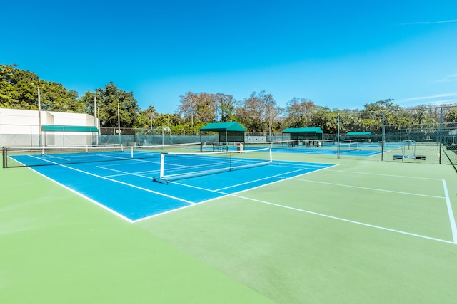 view of tennis court featuring fence