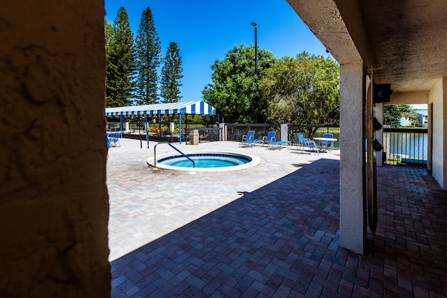 view of swimming pool with a community hot tub and a patio