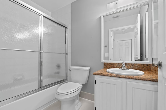 bathroom featuring visible vents, enclosed tub / shower combo, toilet, and vanity