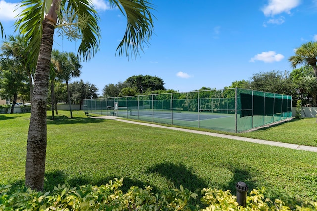 view of sport court featuring a yard and fence