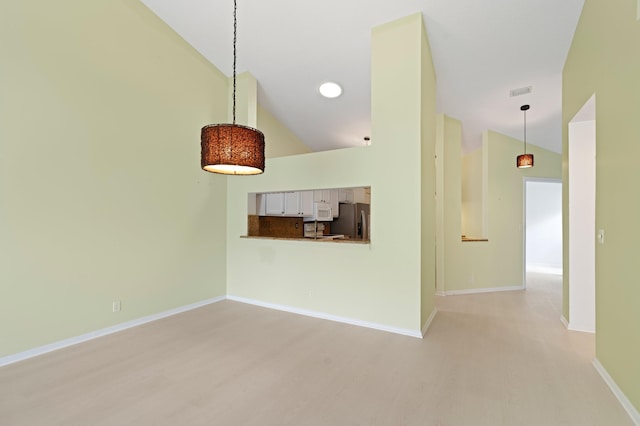 unfurnished living room with visible vents, light wood-style floors, baseboards, and high vaulted ceiling