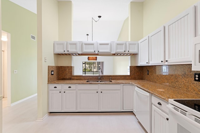 kitchen featuring visible vents, a sink, backsplash, white appliances, and white cabinets