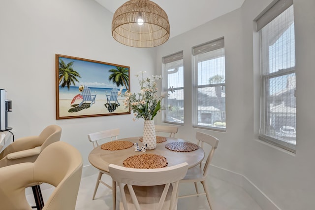 dining space featuring a healthy amount of sunlight and baseboards