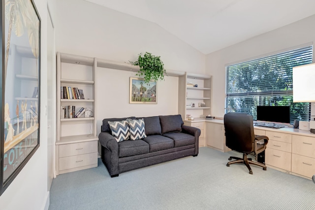 home office featuring lofted ceiling and light carpet