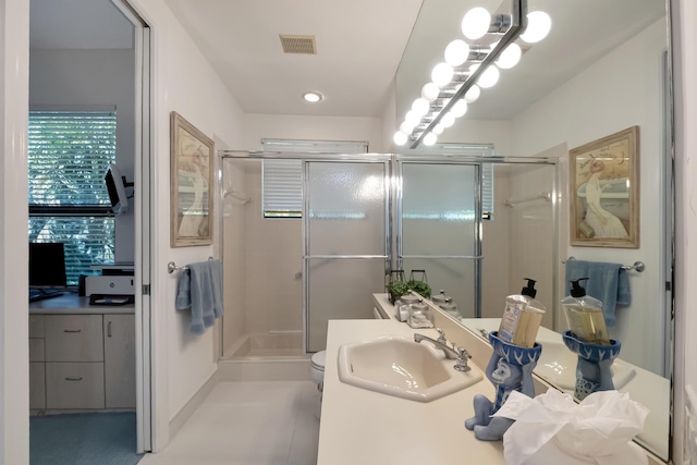 full bathroom with toilet, vanity, a shower stall, and visible vents