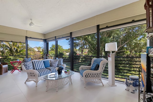 sunroom / solarium featuring a ceiling fan